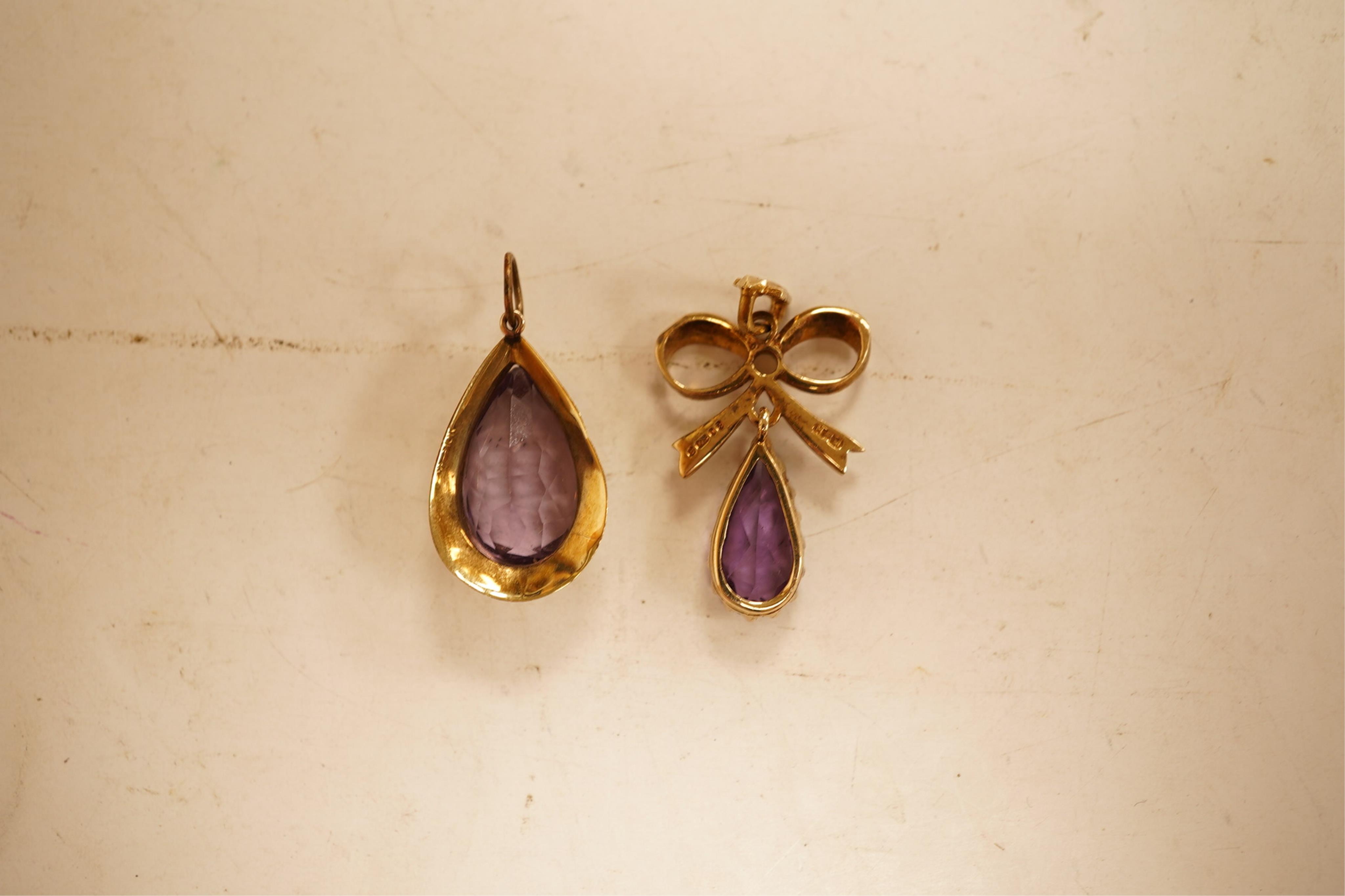 A 1970's 9ct gold, amethyst and seed pearl set drop pendant, 29mm, together with a yellow meta and amethyst set drop pendant.